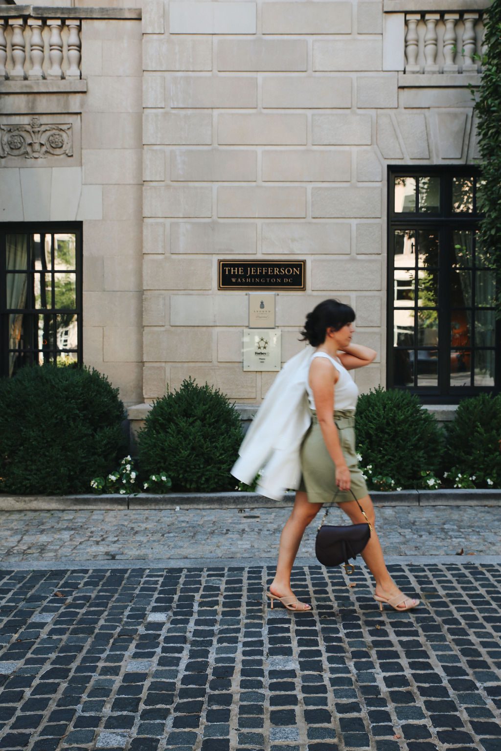 a girl walking in front of the Jefferson DC