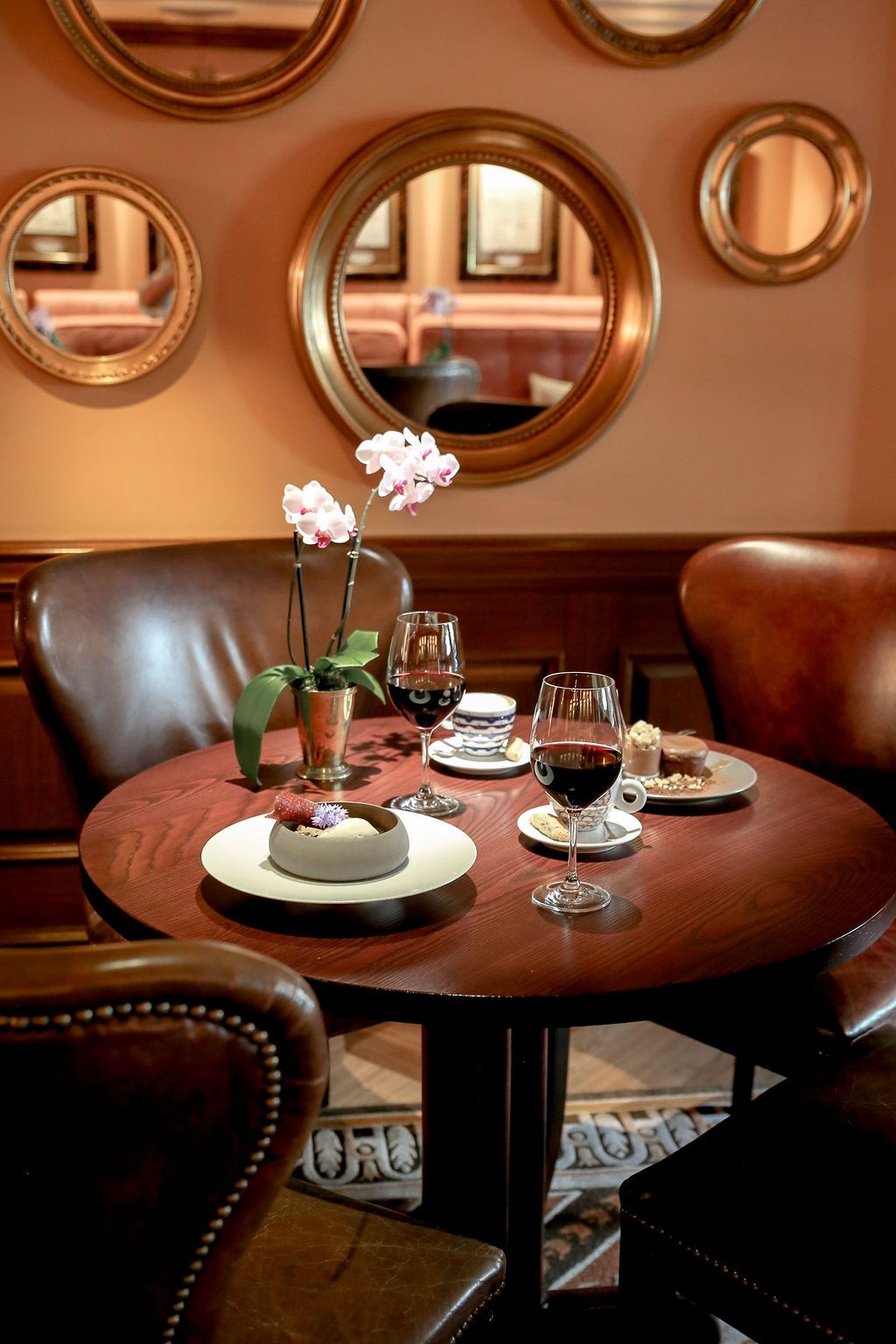 Table with desserts and red wine in Quill