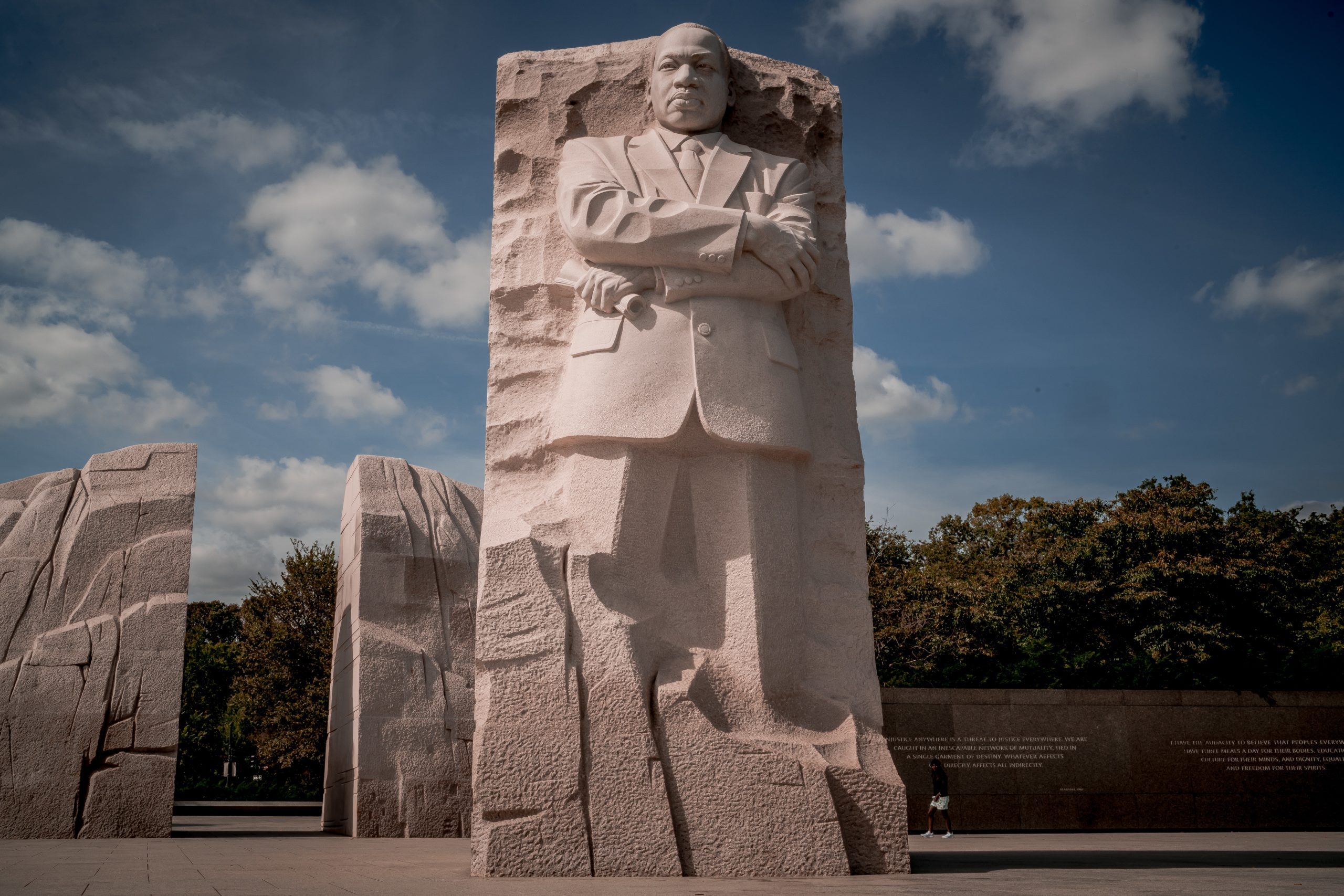Martin Luther King Jr Memorial statue carved in stone with blue sky background in Washington DC