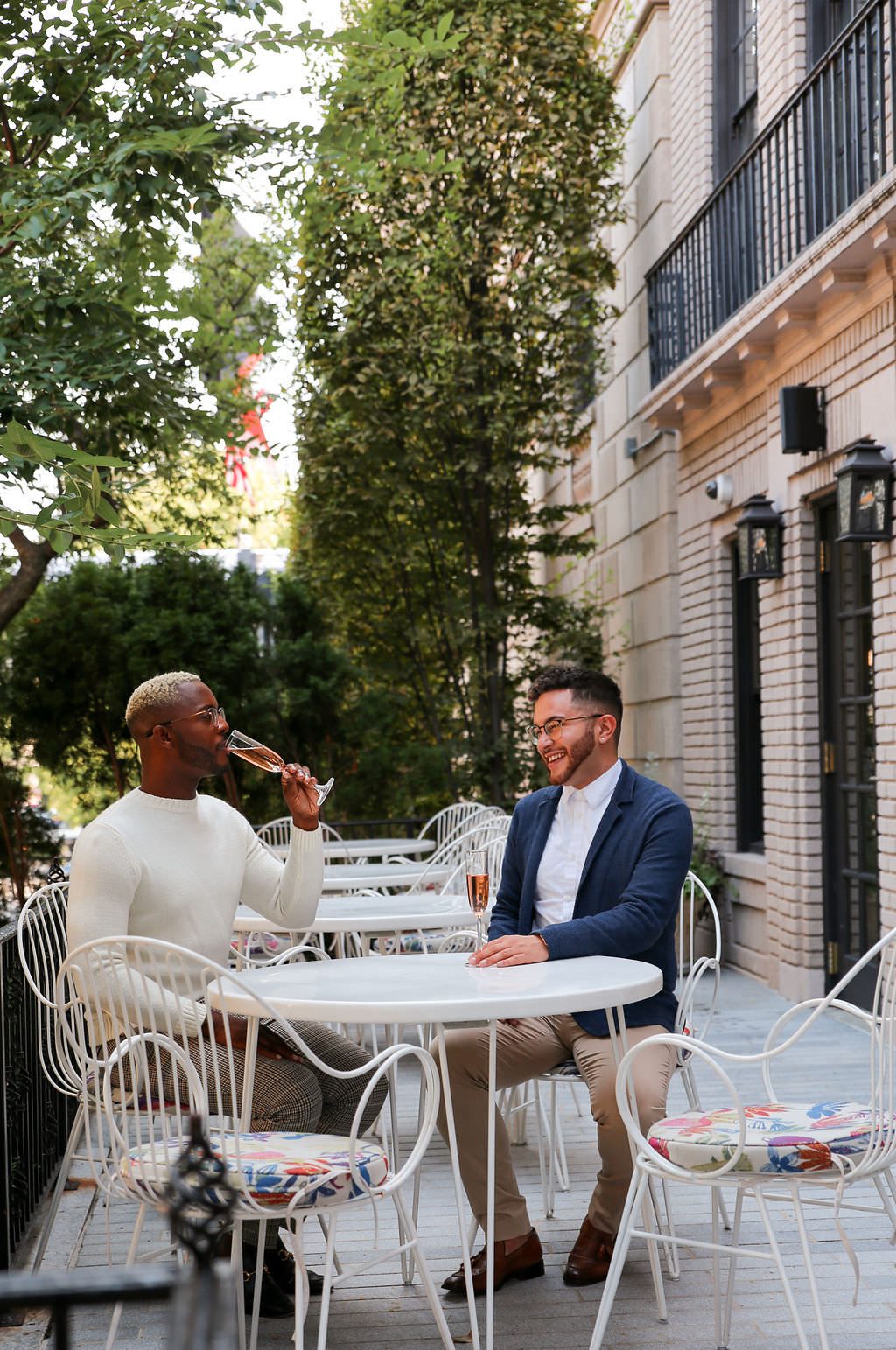 two people sitting outside and drinking